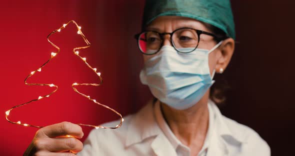 Doctor with Christmas Tree in the Hospital