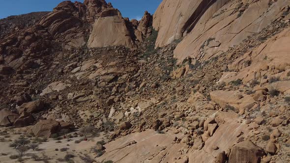 Aerial footage of a side of the rocky mount Erongo in Namibia, desert region