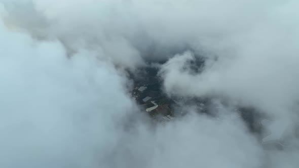 Over the city in the clouds aerila view 4 K