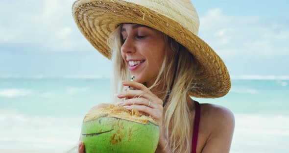 Beautiful Girl Drinking Coconut on the Beach