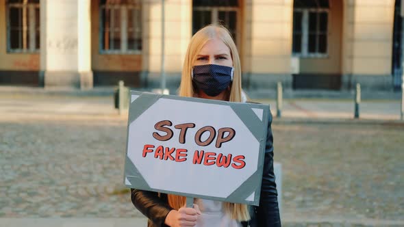 Young Woman in Mask Protesting Against Fake News