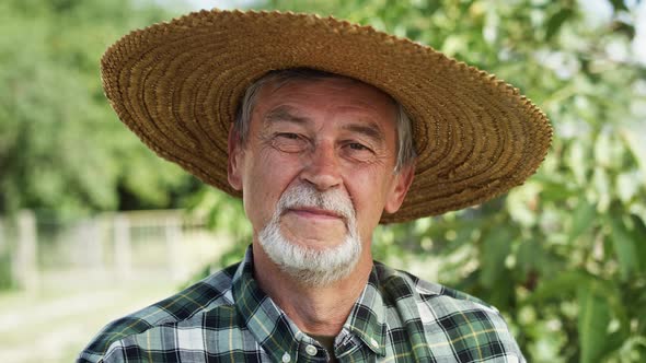 Close up video portrait of farmer in a straw hat. Shot with RED helium camera in 8K