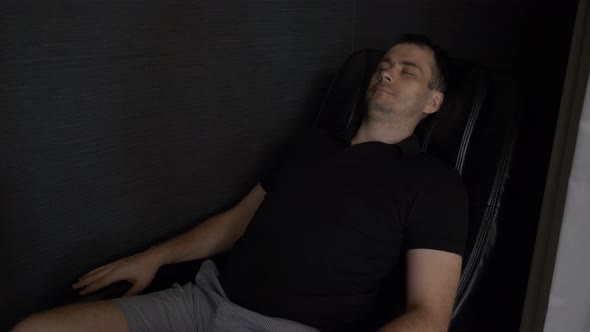 Man Lying Relax and Enjoying in Massage Chair in the Lounge Area in Airport