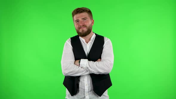 Guy Listens Carefully with a Smile and Then Waves His Finger. Green Screen