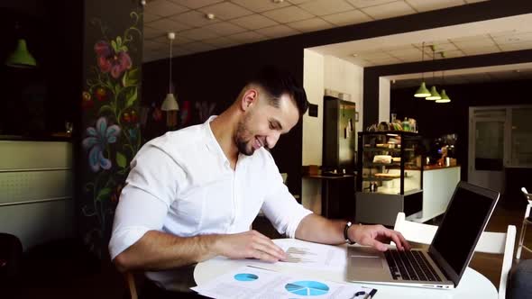 Slow Motion Candid Image of a Pensive Businessman in a Cafe