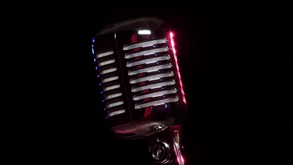 Classic Vocal Microphone Slow Rotating and Reflects Stage Lights