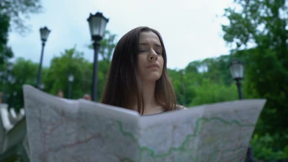 Girl Tourist Looking at Map, Successfully Finds Way to Historical Attraction