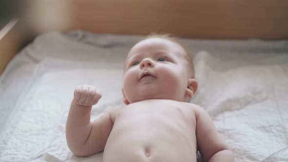 Adorable Newborn Boy with Blond Hair and Plump Cheeks