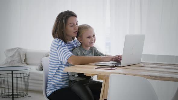 Mother working from home with daughter