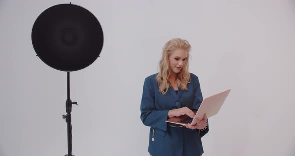 Girl Working On A Laptop In The Studio On A White Background