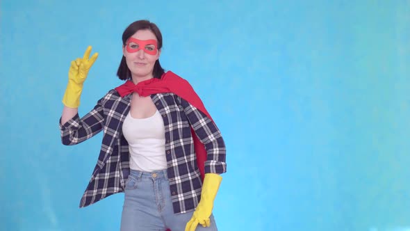 Young Superhero Woman Housewife Dancing on Blue Background