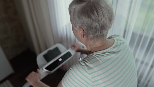 Woman with Grey Hair on a Treadmill