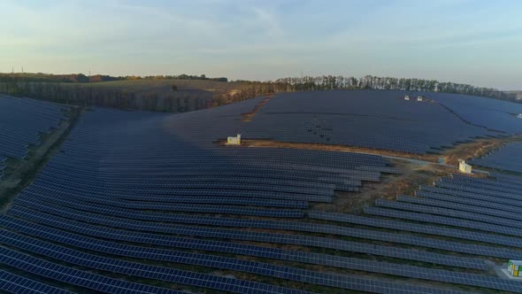 Aerial Drone Footage. Flight Over Solar Panel Farm at Sunset Autumn Season.