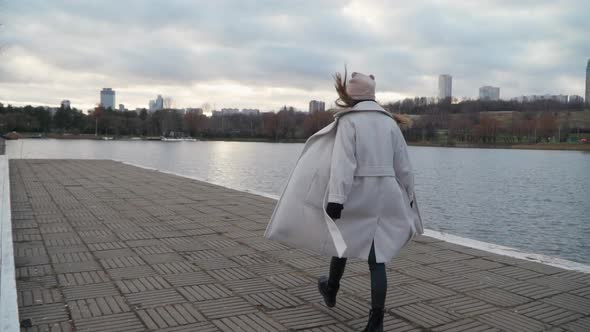 Girl Walks Along the Stunning Embankment