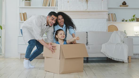 Funny Active Multiracial Parents Mom Dad Multiethnic Family Playing on Moving Day at New Home