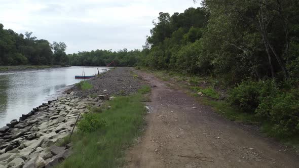 Move along the rural path toward the excavator