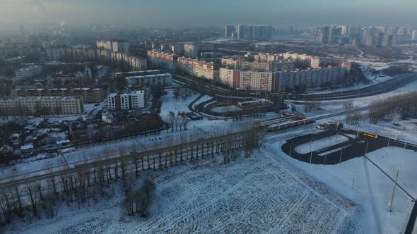 Flight over the city block. Winter cityscape. There is a railway line nearby.