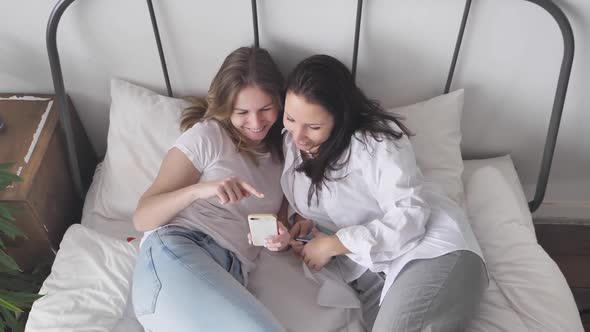 Young Women in White T-Shirt Falling on Couch Connection People Use Smartphone