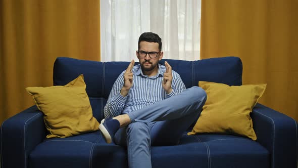 Excited Male Football Fan Supports Favorite Team Crosses Fingers and Believes in Success Clenches