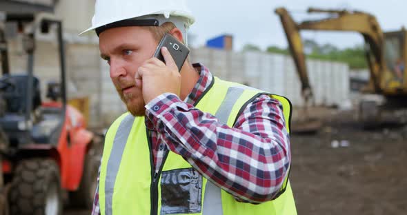 Male worker talking on mobile phone 