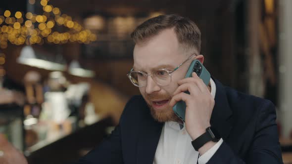 Businessman Talking Via Smartphone with Colleague Arguing