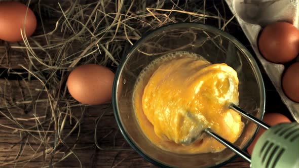 Super Slow Motion Fresh Eggs are Stirred By a Mixer