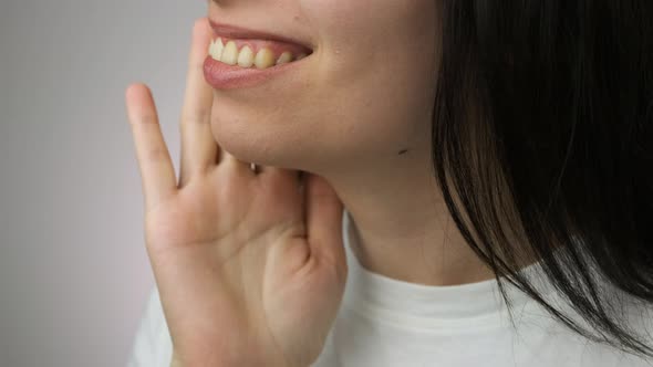 Front View of Woman Removing Invisible Transparent Aligner From the Upper Jaw and Demonstrate Smile