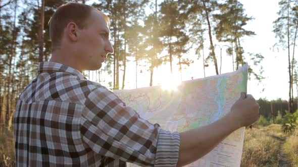 Man is Traveling, Uses a Map and Compass