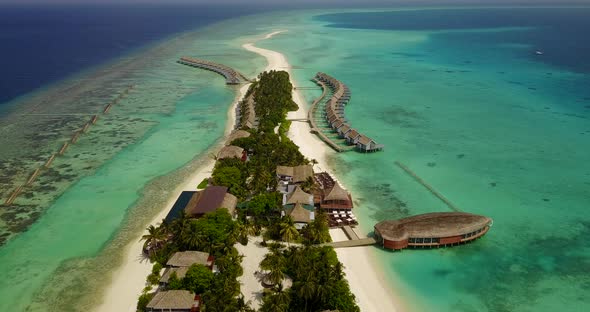 Luxury aerial travel shot of a white paradise beach and blue water background in vibrant 4K