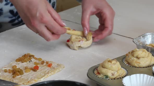 A Woman Prepares A Cruffin With Raisins And Candied Fruits.