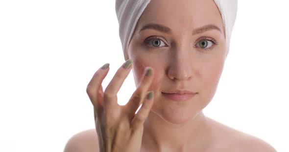 Portrait of a Charming Fit European Young Woman with a Hair Drying Towel on Her Head Applies