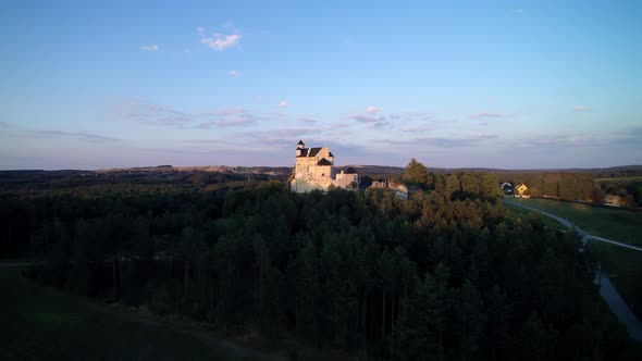Castle in the forest, sunset, view from a drone 
