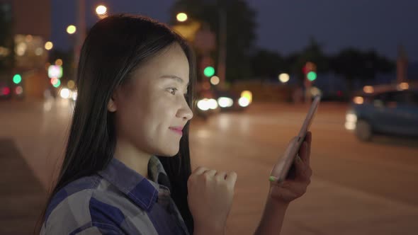 Young Asian Female Using Tablet Computer Screen