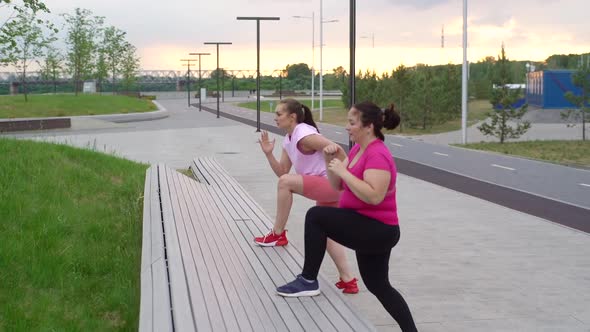 Overweight Young Woman Doing Single Leg Squats with Personal Trainer Outdoor in Cloudy Summer