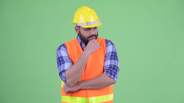 Stressed Young Overweight Bearded Indian Man Construction Worker Thinking