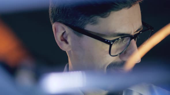 Close Up of Male Expert's Face in Glasses Being Curious