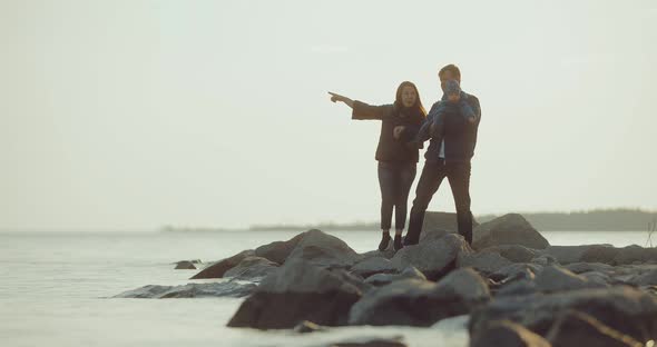 Korean Woman with Her Husband and Young Son Stands on the Seashore