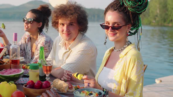 Portrait of Young Male and Female Friends at Lake Party