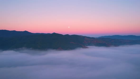 4K Drone Flying through the clouds at dusk or dawn. Aerial top cloudscape