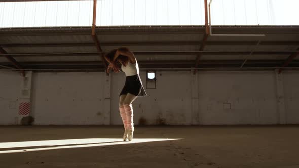 Female dancer in an empty warehouse