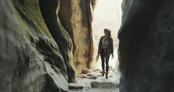 Young Traveler Girl Walking at Rocks