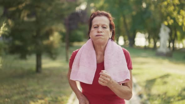 Tired Mature Woman Running in the Park