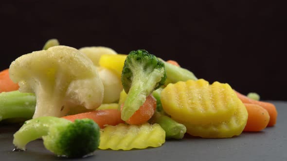 Fresh Frozen Vegetables Rotating on Black Background Healthy Food or Diet Food for Vegetarians and