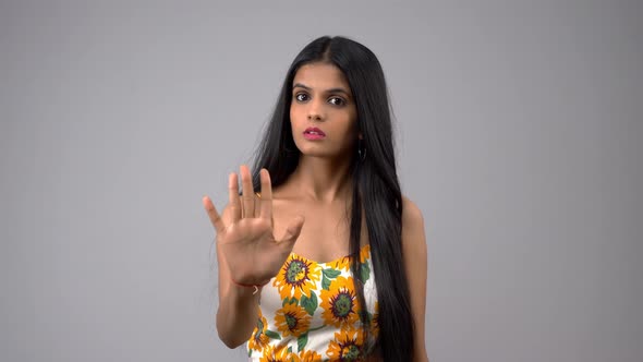 Angry Indian girl gesturing STOP