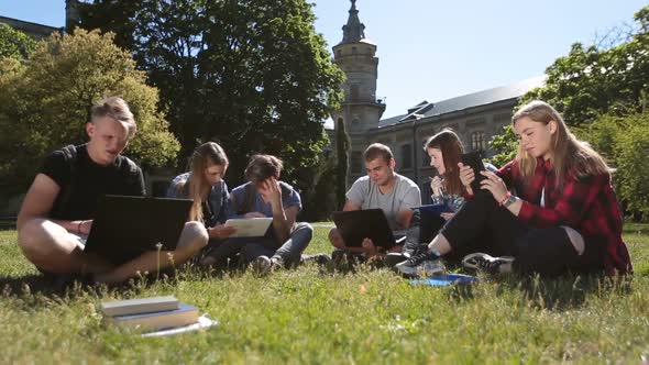 Students Studying with Laptop and Tablet on Grass