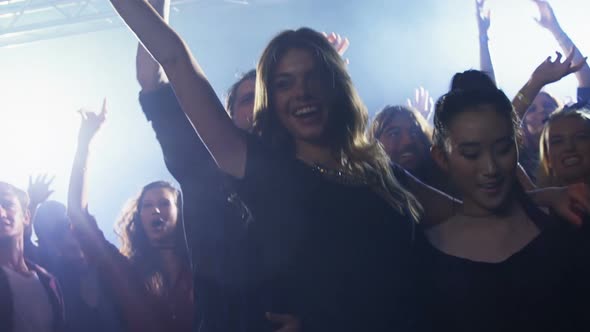 Group of people dancing at a concert 4k