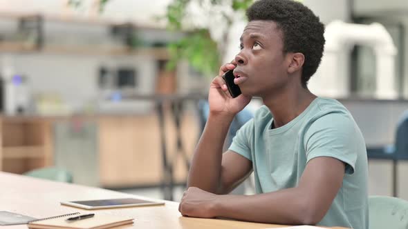 Young African Man Talking on Smartphone Phone Call