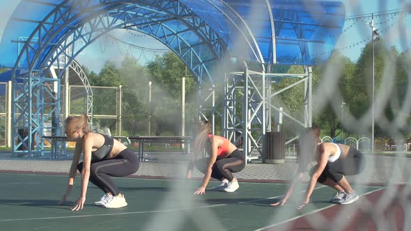 Group of women working out outdoors. Training and doing exercises