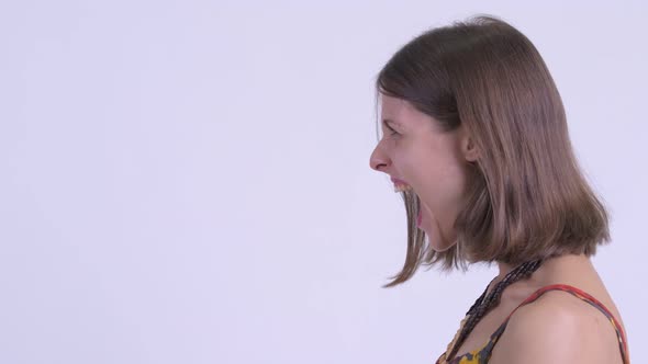 Closeup Profile View of Angry Young Hipster Woman Shouting and Screaming