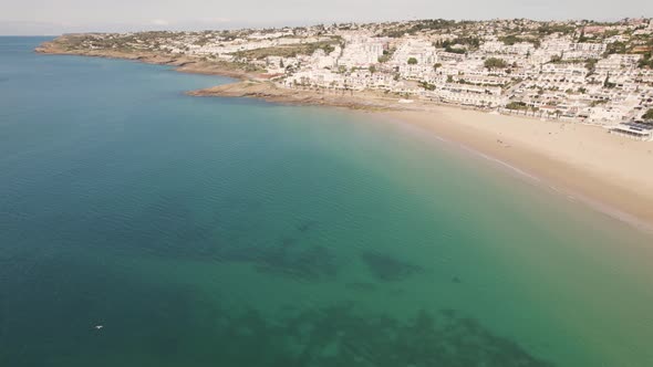 Tranquil scene, calm emerald ocean and white townhouses of Praia da Luz. Panoramic aerial